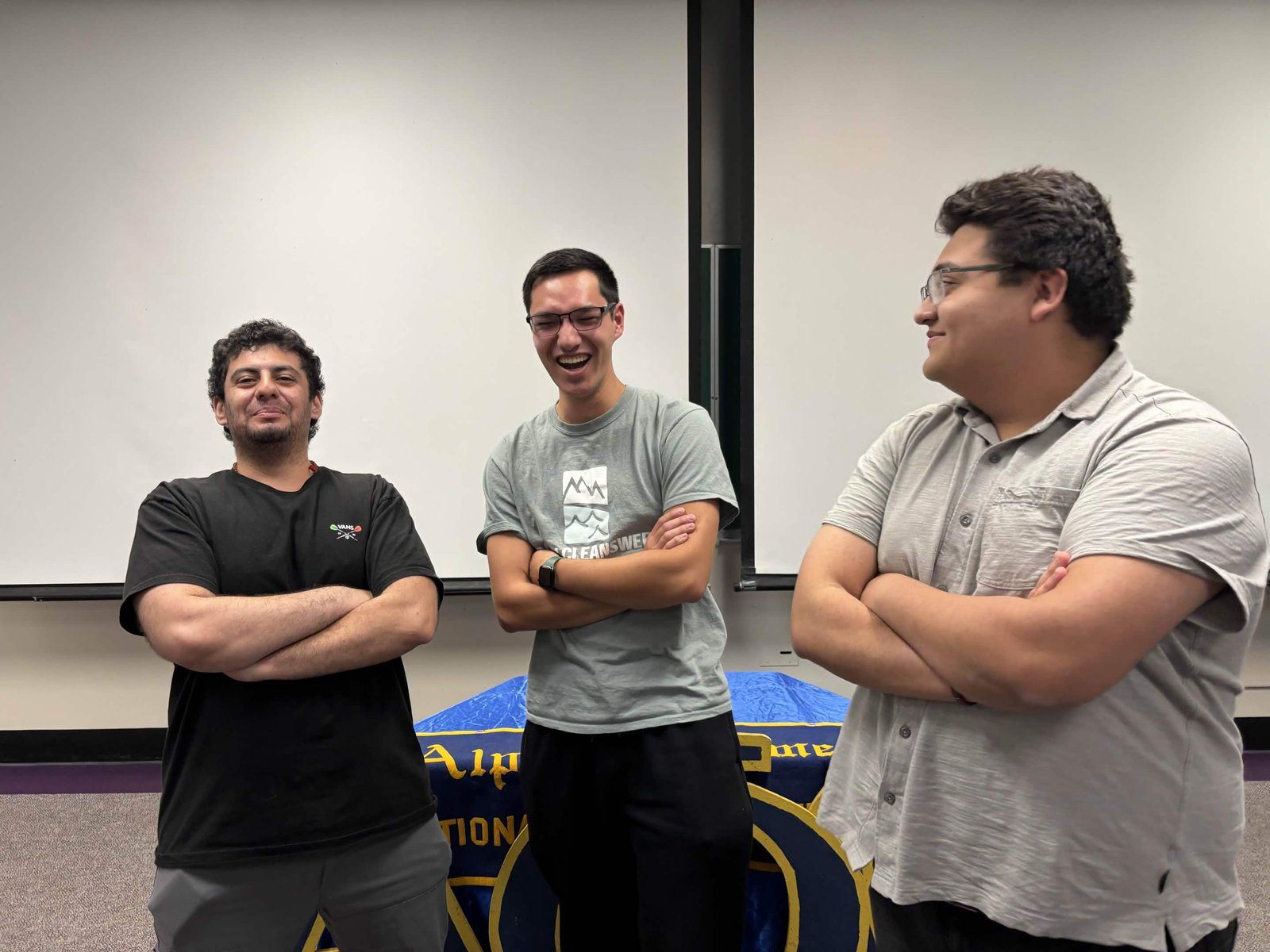 Armaan with members of his E Tree family in front of the Alpha Phi Omega banner