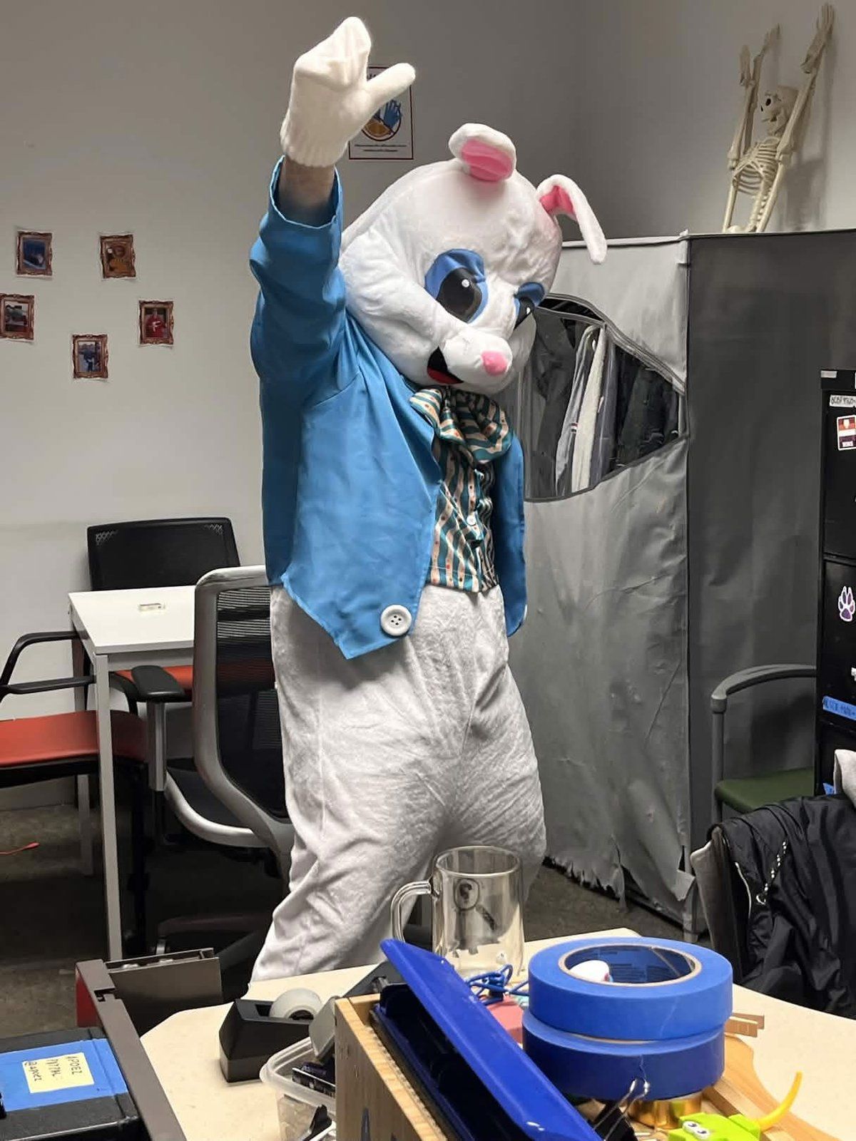 A youth group member posing with the Easter Bunny mascot at the Youth Service Day Easter celebration