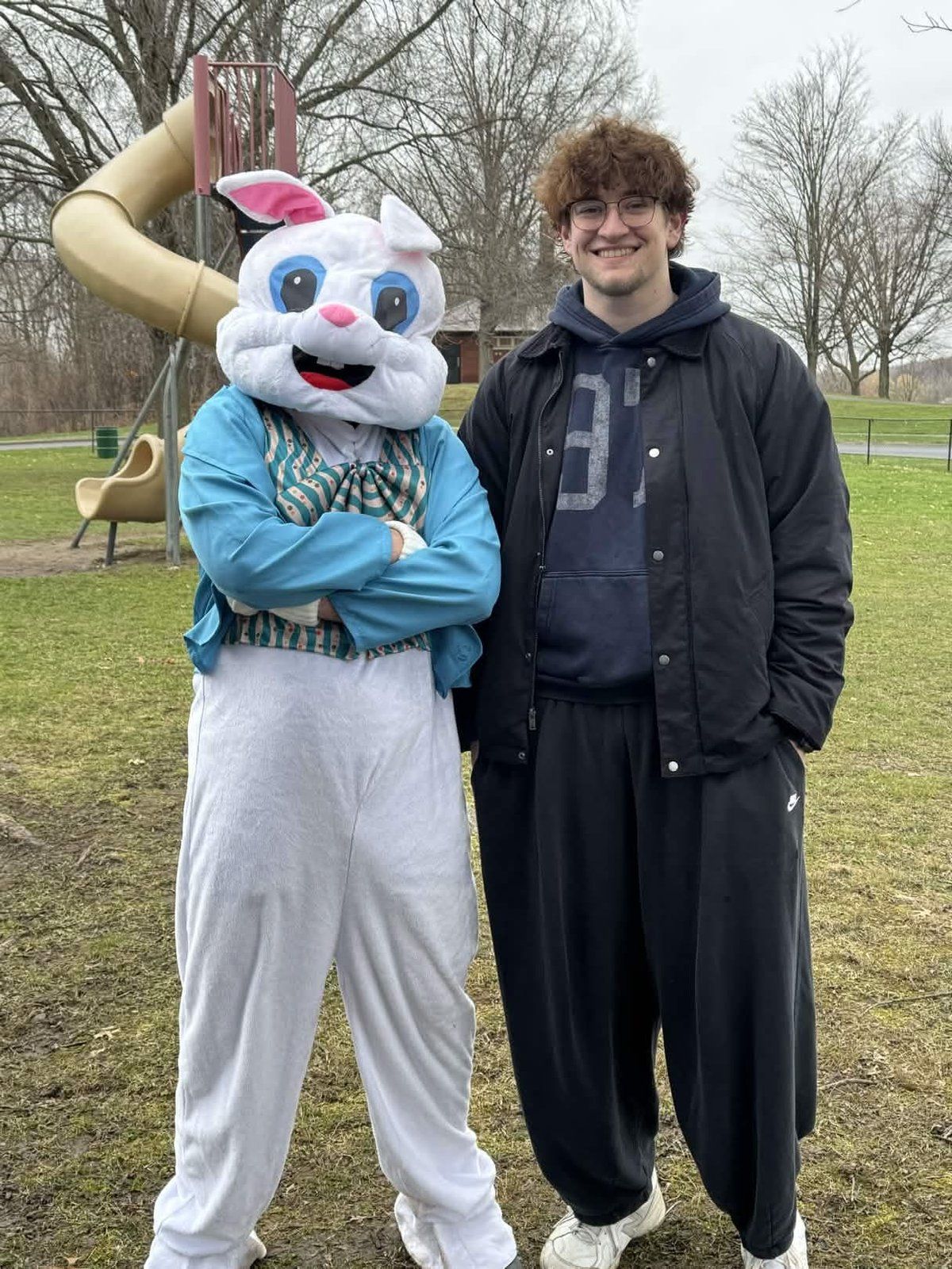 A youth group member posing with the Easter Bunny mascot at the Youth Service Day Easter celebration