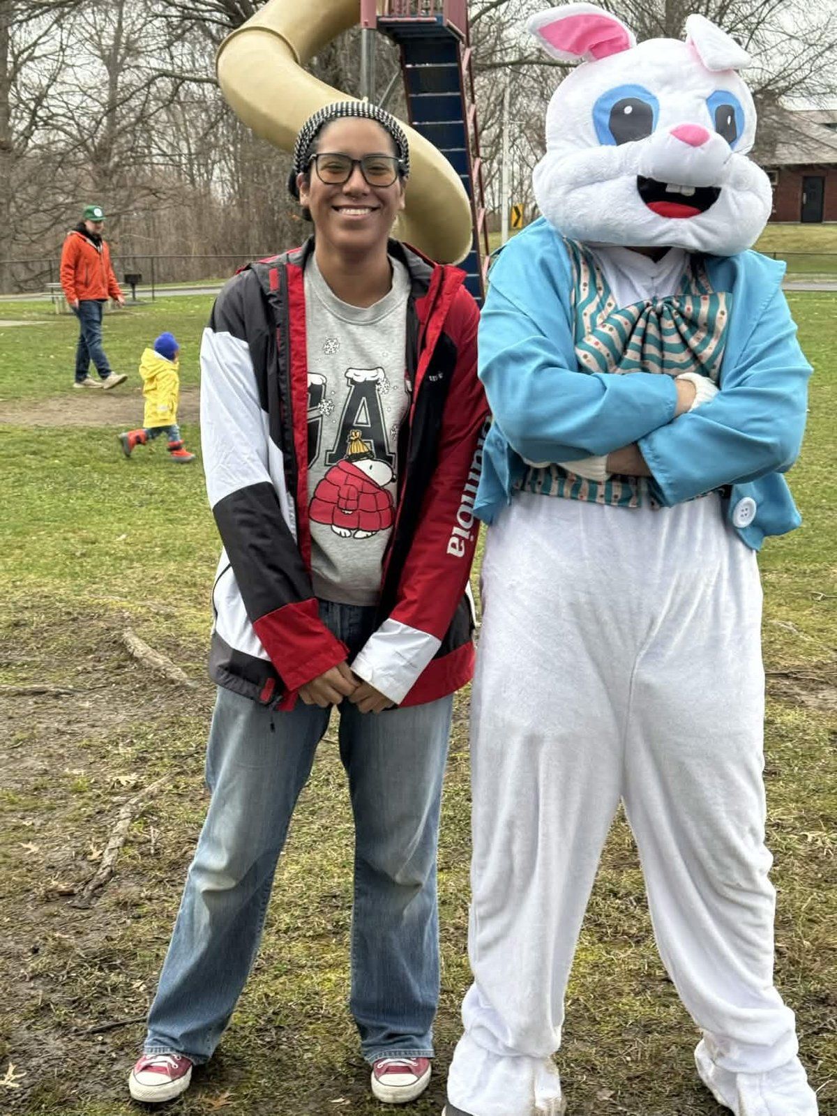 A youth group member posing with the Easter Bunny mascot at the Youth Service Day Easter celebration