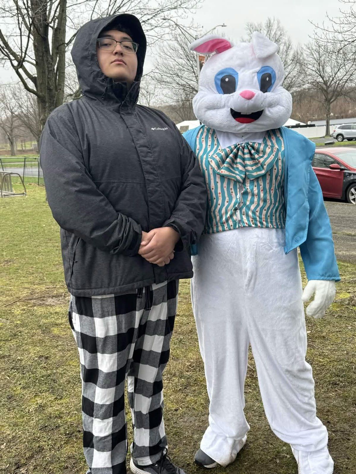 Armaan posing with the Easter Bunny mascot at the Youth Service Day Easter celebration