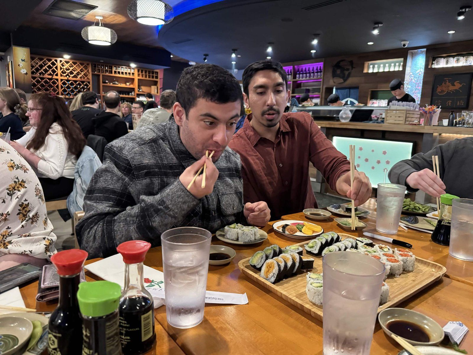 Armaan eating sushi with a fellow Alpha Phi Omega member at Wasabi