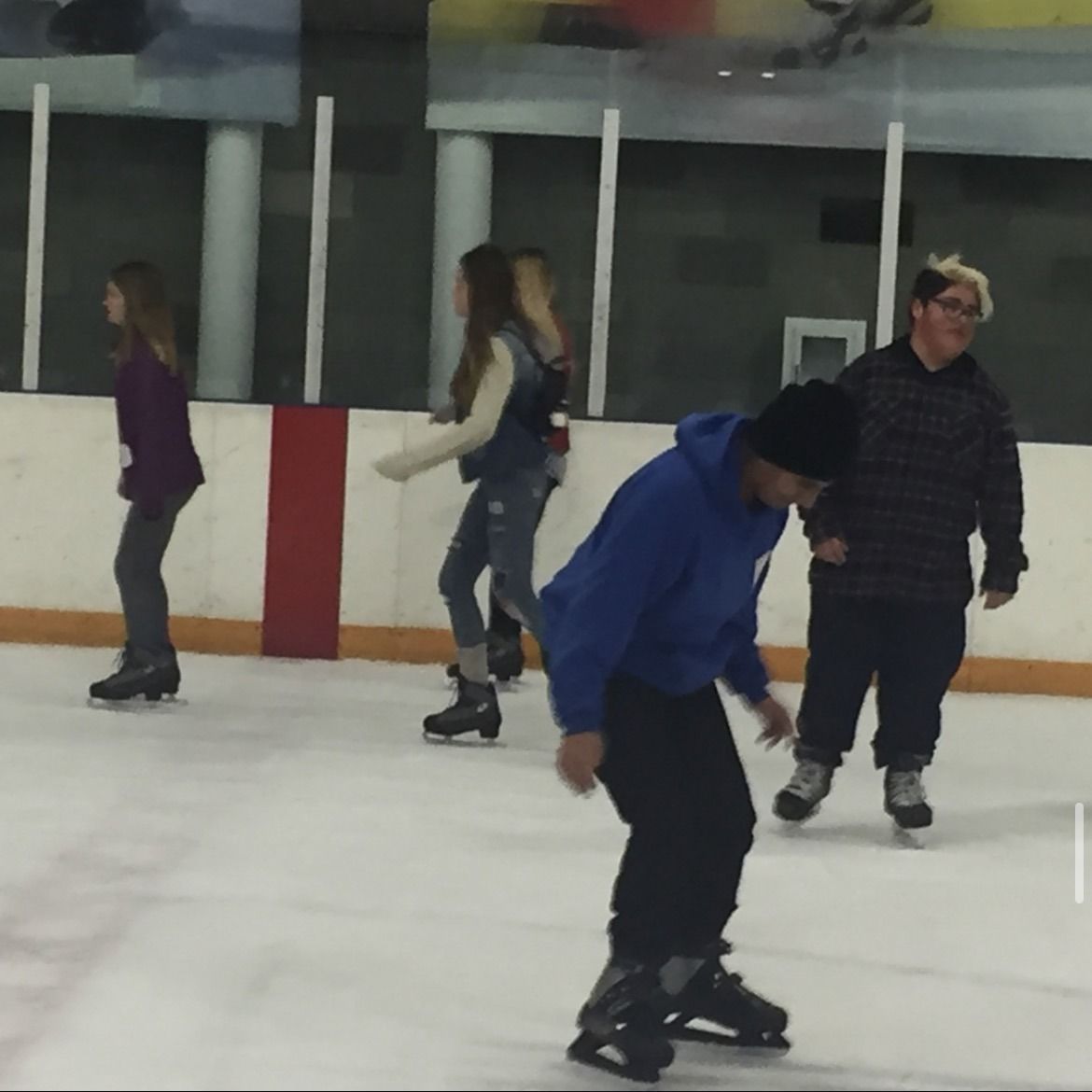 Youth group members ice skating at Toyota Center