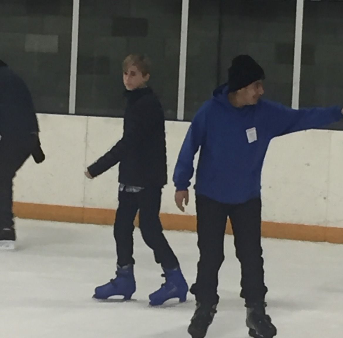 Youth group members ice skating at Toyota Center